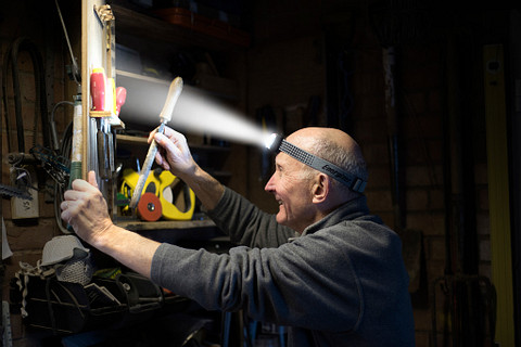 ENR_Headlights_Vision HD Plus Focus_Workshop_A a man wearing an Energizer Vision HD+ Focus Industrial Headlamp organizing his tools