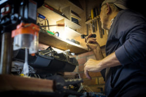a man looking for a tool with the help of the Energizer Performance Metal Tactical Flashlights