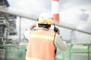 a man wearing safety equipment talking on the radio