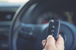 Woman holding a car key. a woman holding a car keyfob