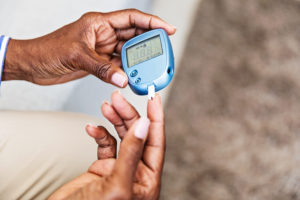 Measuring Blood Sugar woman with diabetes checking her blood sugar